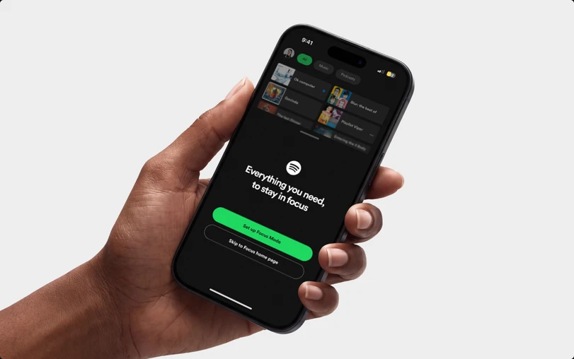 A hand holding a phone showing the Focus Mode intro sheet: “Everything you need, to stay in focus”